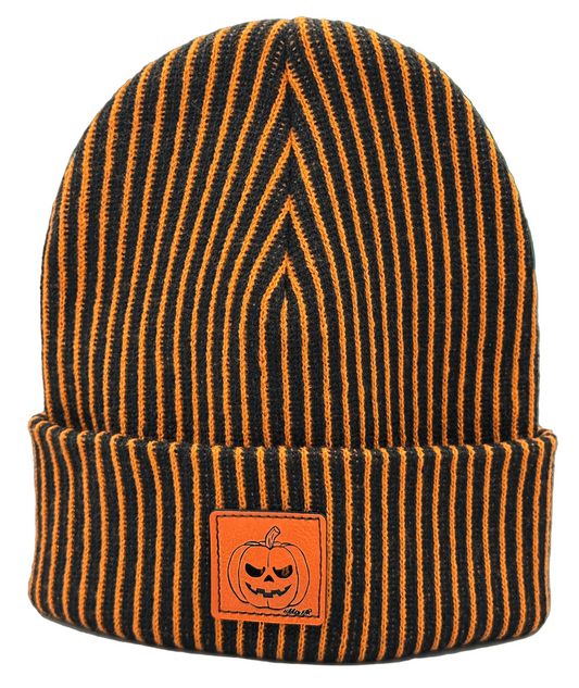 Striped knit beanie with orange pumpkin face patch, dark orange and black stripes