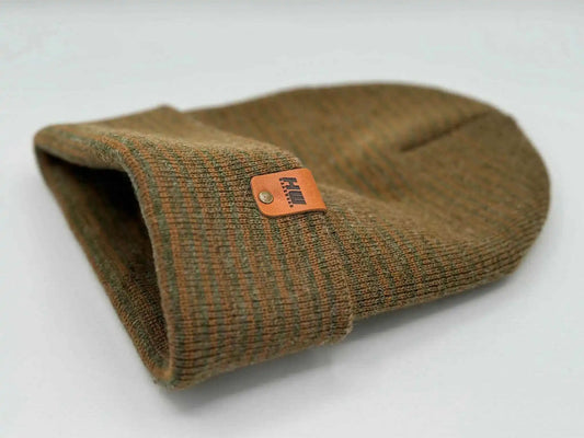 Brown and green contrast cuff beanie, folded with orange logo label on edge