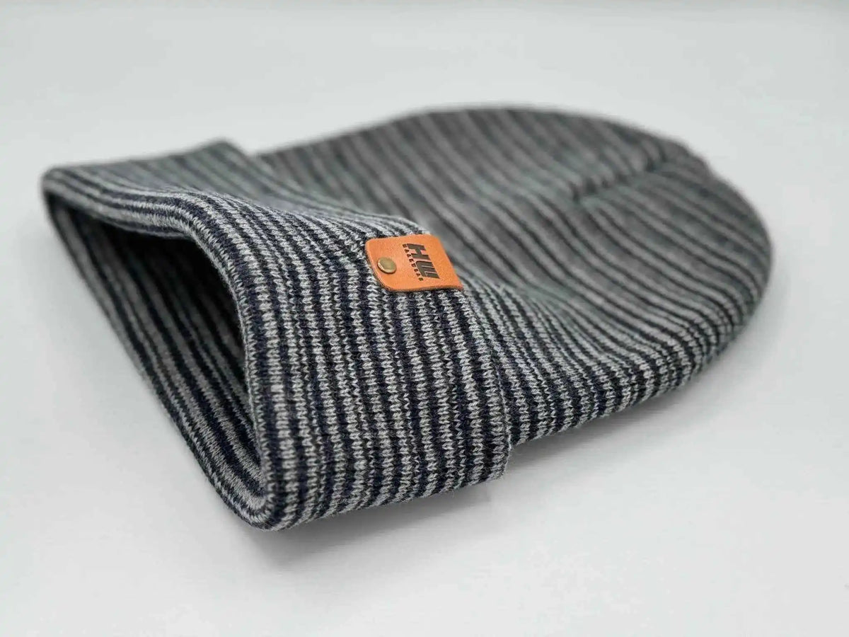 Folded beanie, gray and navy striped knit with orange logo patch on cuff