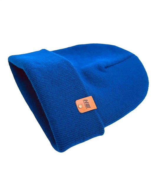 Sapphire blue knit beanie, folded cuff, tan logo patch at side