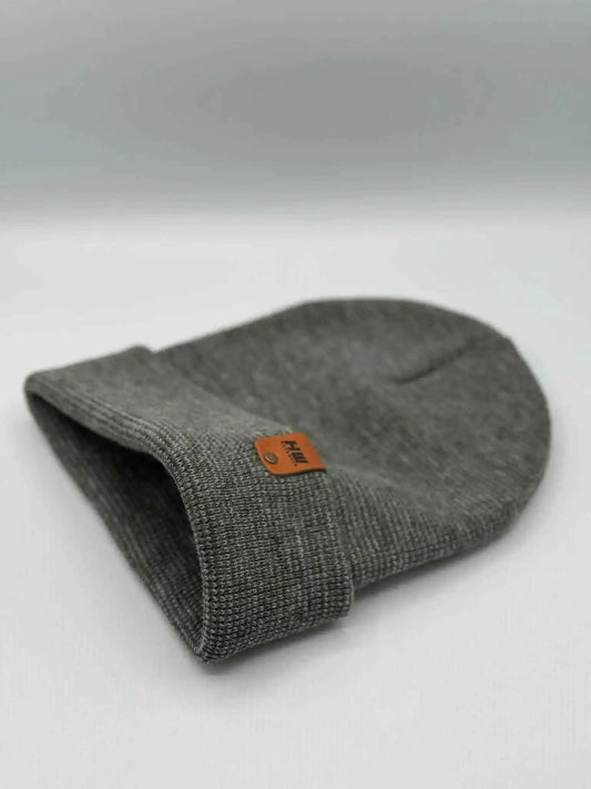 Gray cuffed beanie folded over, orange brand patch on cuff
