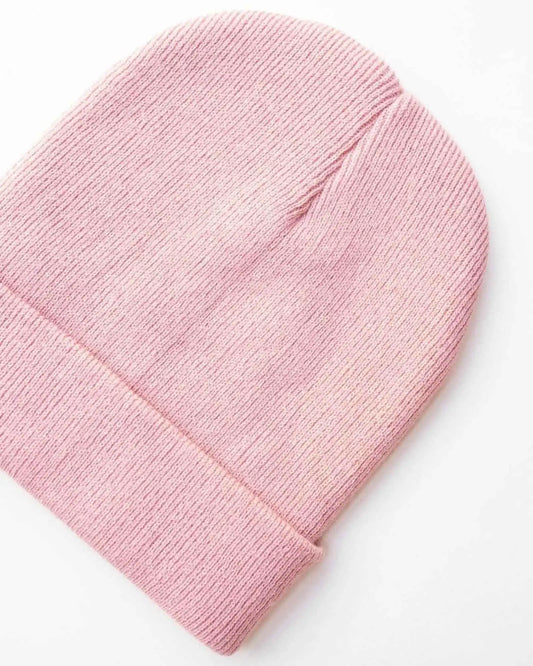 Pink ribbed knit beanie with folded cuff edge and close-up knit texture