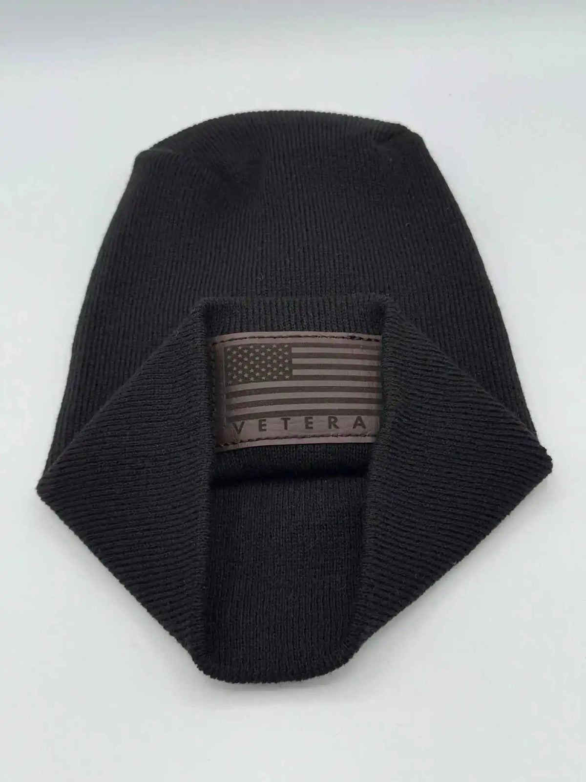 Cuffed knit beanie in black with a Veterans flag patch on the front cuff