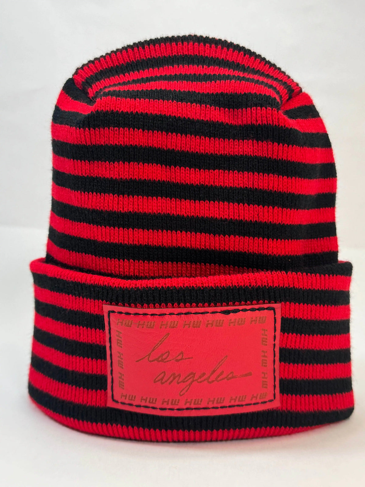 Black and red striped beanie with fold cuff and rectangular front logo patch