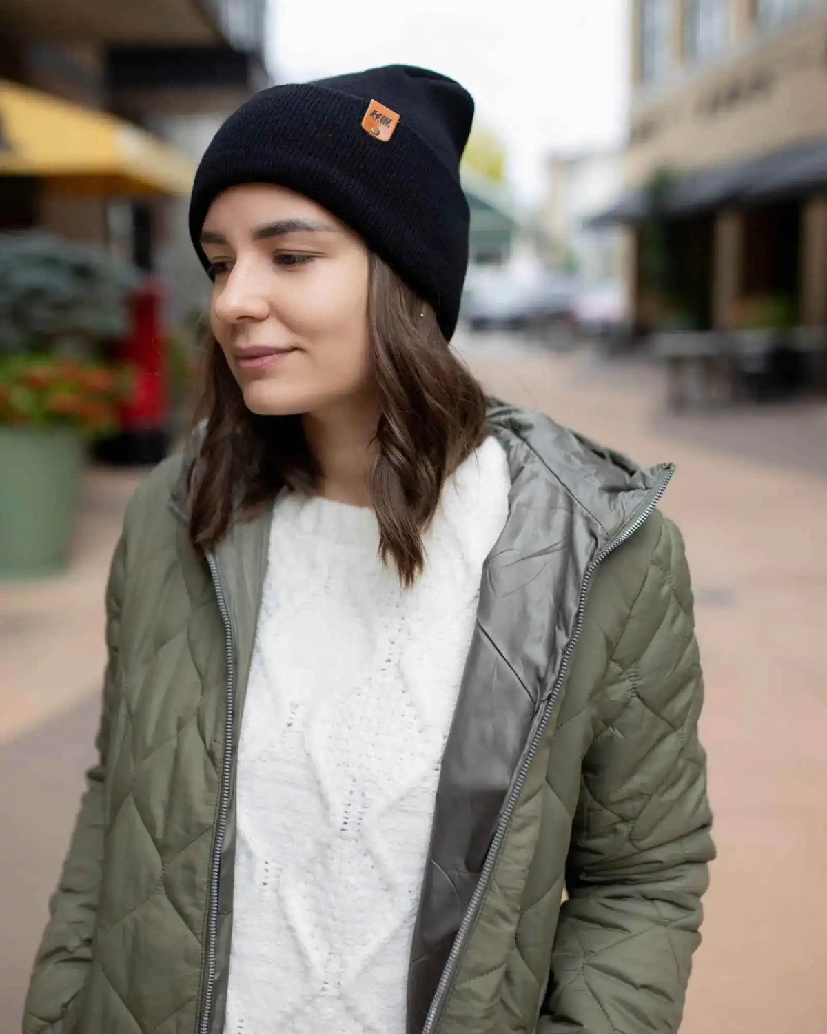 Midnight black cuffed beanie with knit texture and rectangular logo patch
