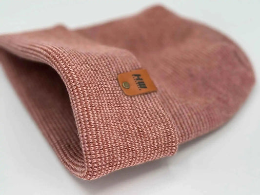 Cuffed burgundy beanie knit with woven texture and logo patch near cuff