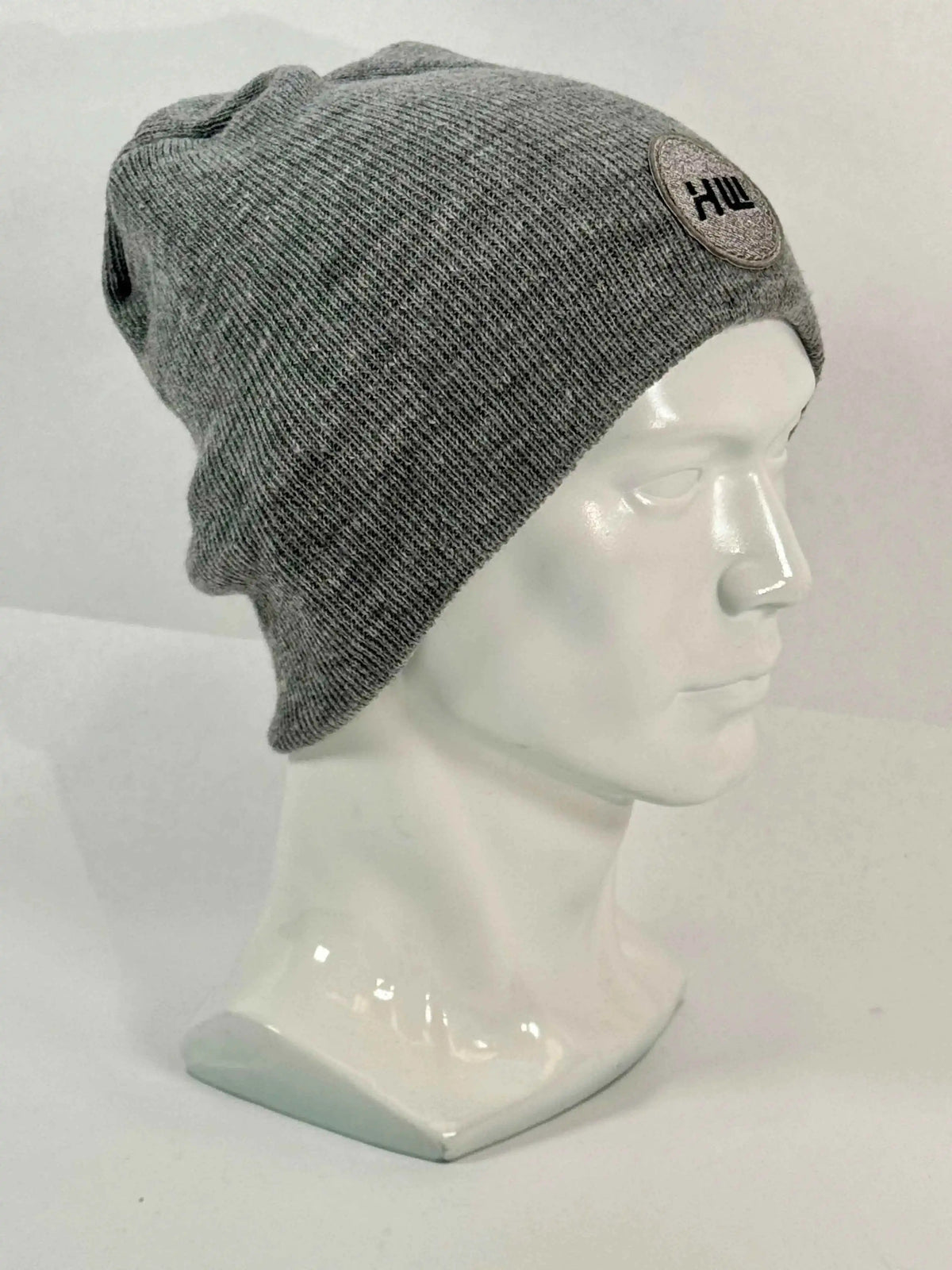 Gray knit beanie, uncuffed fit, ribbed texture and side round logo patch