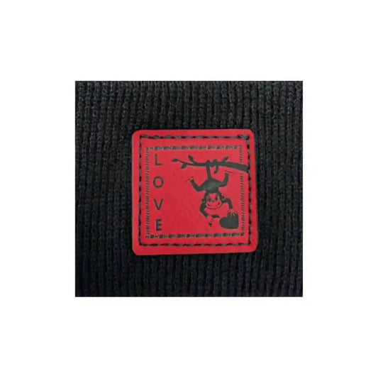Black knit beanie cuff close-up with red square love monkey patch