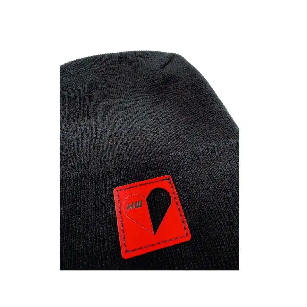 Black beanie with red logo patch and stitched border