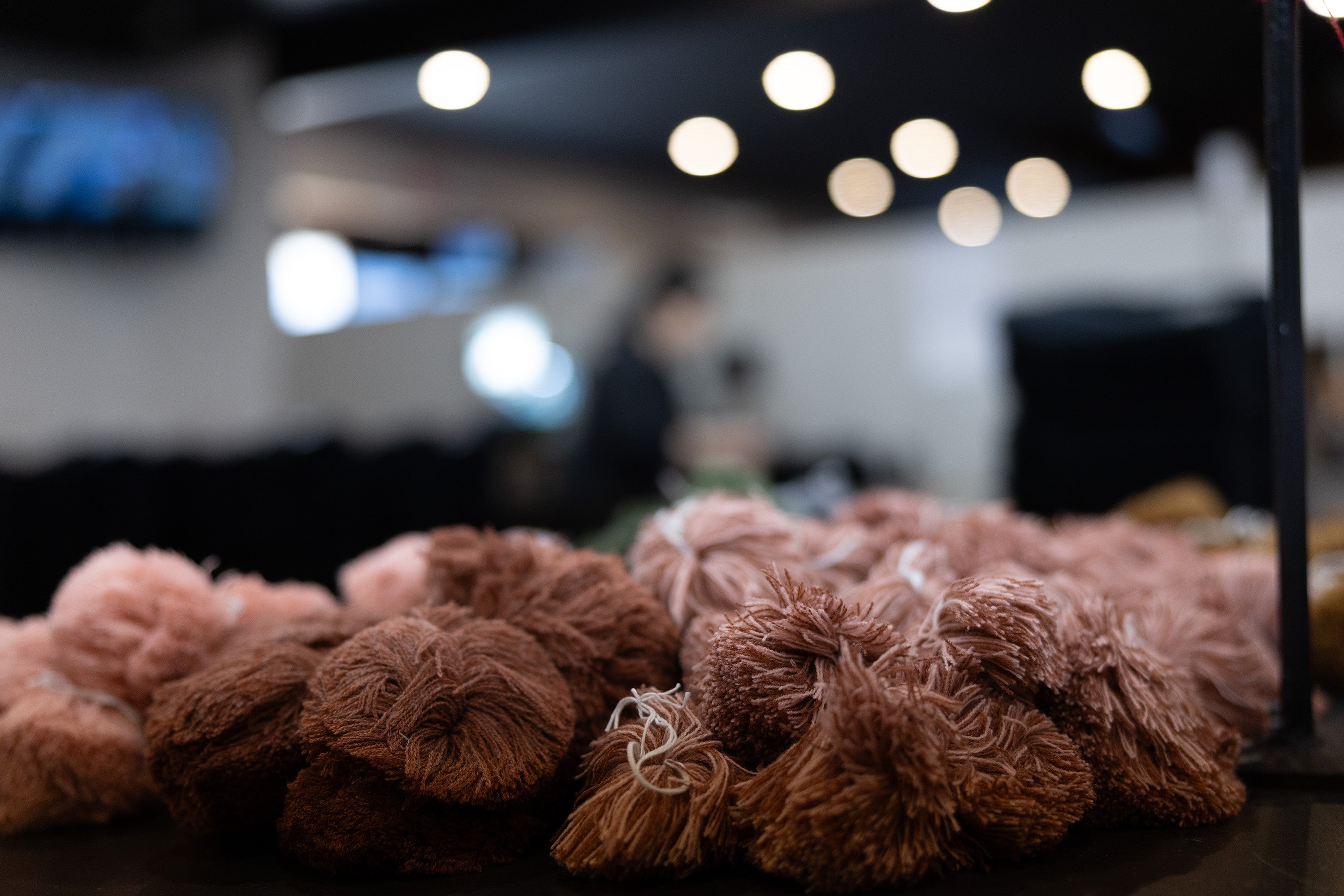 Close-up of brown textured yarn on a blurred indoor background