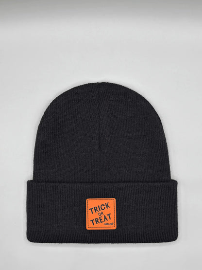 Dark Halloween beanie with orange “Trick or Treat” logo patch on cuff