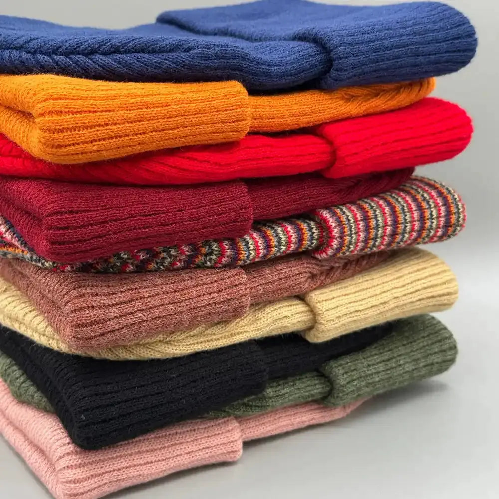 Kids knit beanie stack with folded cuffs in blue, orange, red, tan, and green