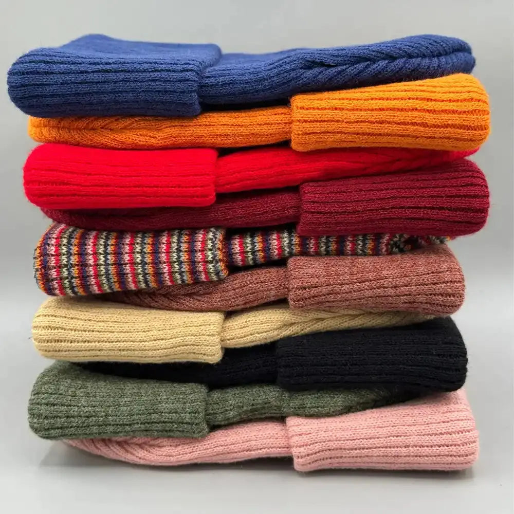Kids knit beanie stack with folded cuffs in blue, orange, red, and beige