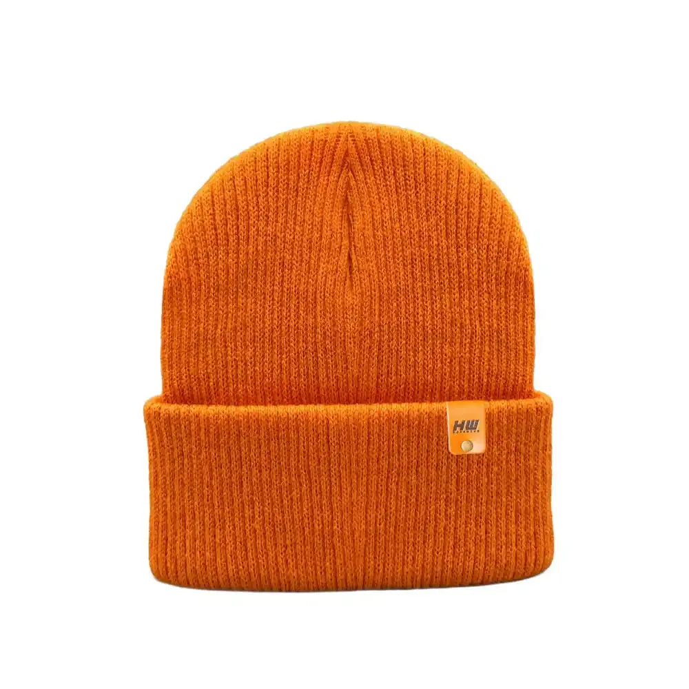 Kids cuffed knit beanie in bright orange with small logo tag on cuff