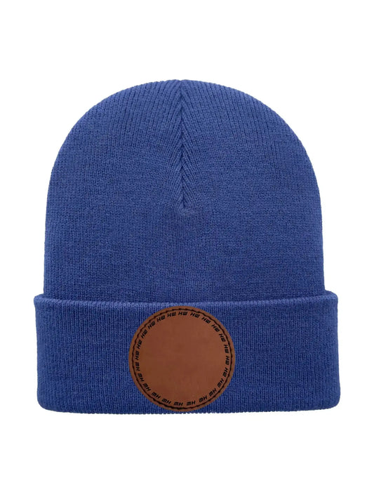 Blue knit beanie with folded cuff and round logo patch at the front.
