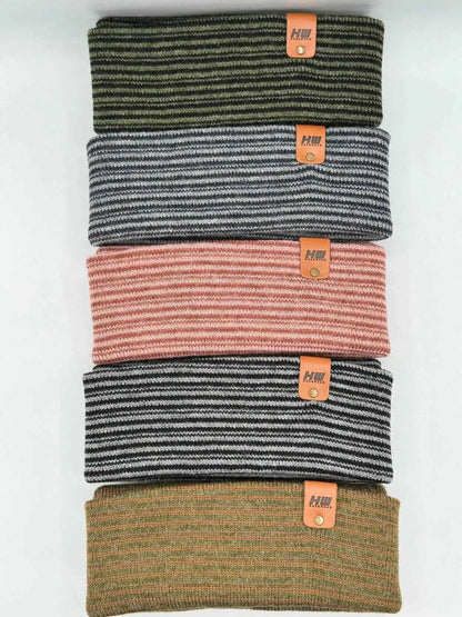 Stack of ribbed cuff beanies with striped knit in mixed colors and orange logo tags