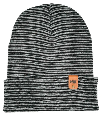 Striped knit beanie in black and gray with folded cuff and small orange logo patch