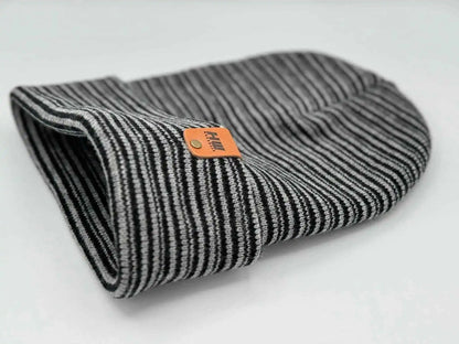 Black-and-gray striped ribbed beanie with folded cuff, orange logo patch