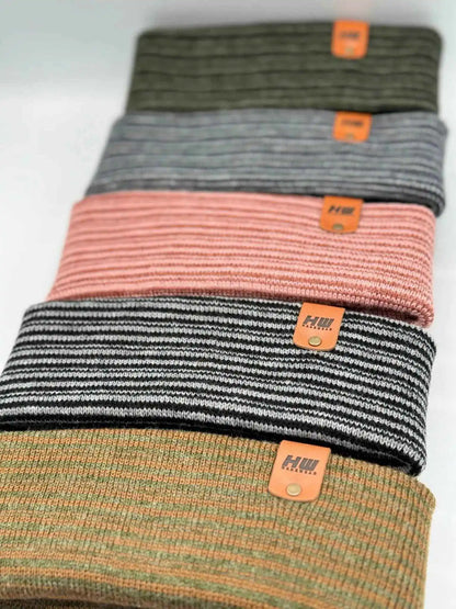 Ribbed cuff beanie stack in black, pink, orange, and green with orange logo patches