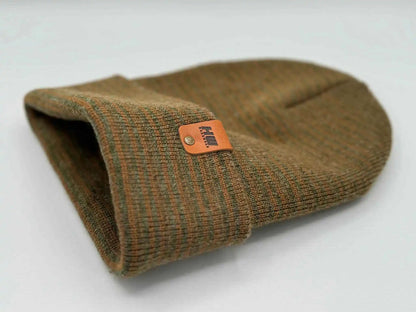 Brown and green contrast cuff beanie, folded with orange logo label on edge
