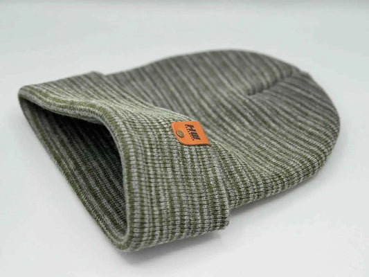Gray-green knit beanie with folded cuff, side view, orange logo patch