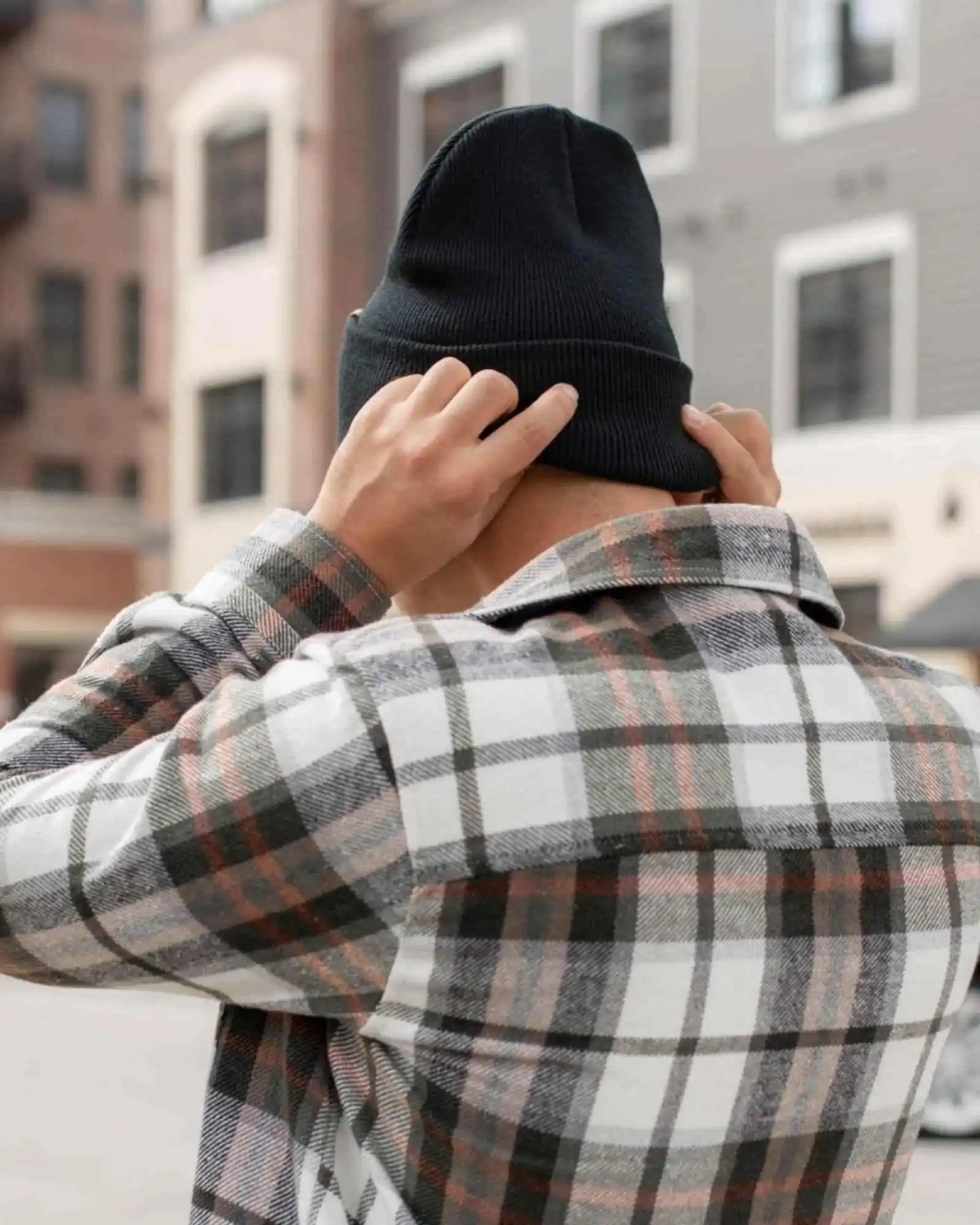 Charcoal black ribbed knit cuffed beanie, folded brim.