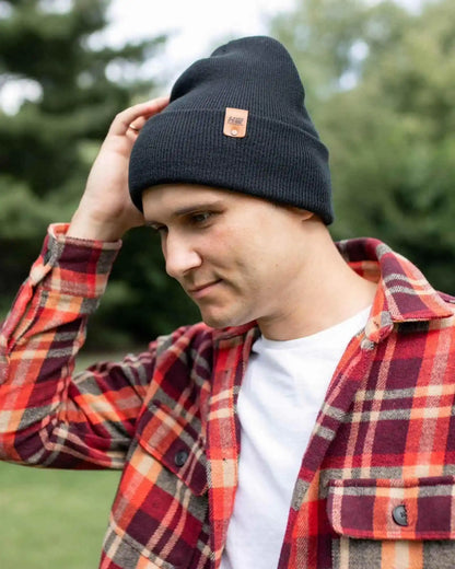 Charcoal black cuffed beanie with fold-over brim and small leather logo patch.
