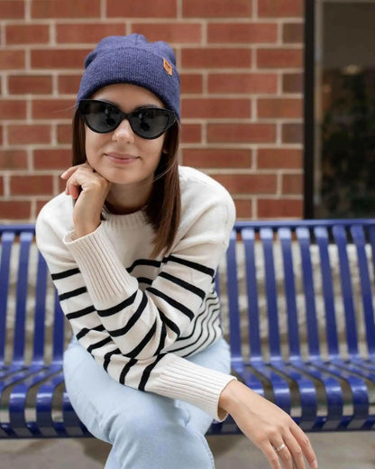 Denim blue cuffed knit beanie with tan logo patch