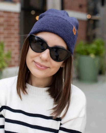 Denim blue cuffed beanie with ribbed knit texture and small logo patch