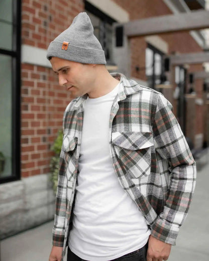 Gray knit cuff beanie on person, folded brim with brown logo patch
