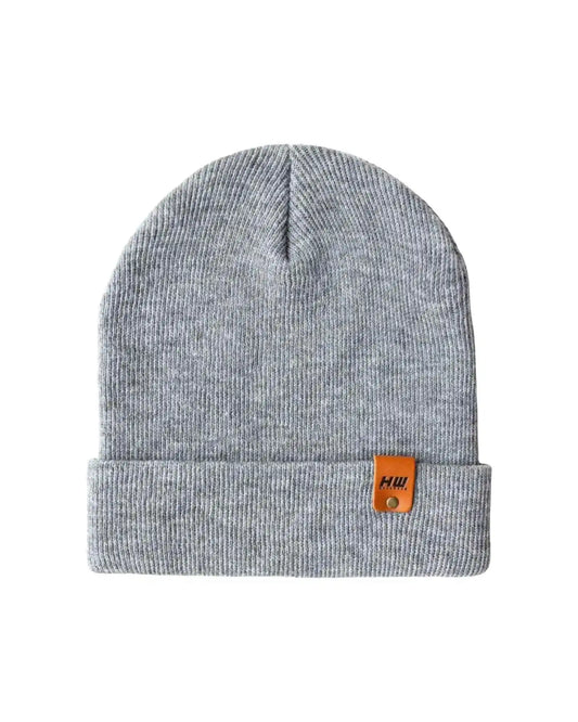Gray knit cuff beanie with folded brim and small brown logo patch