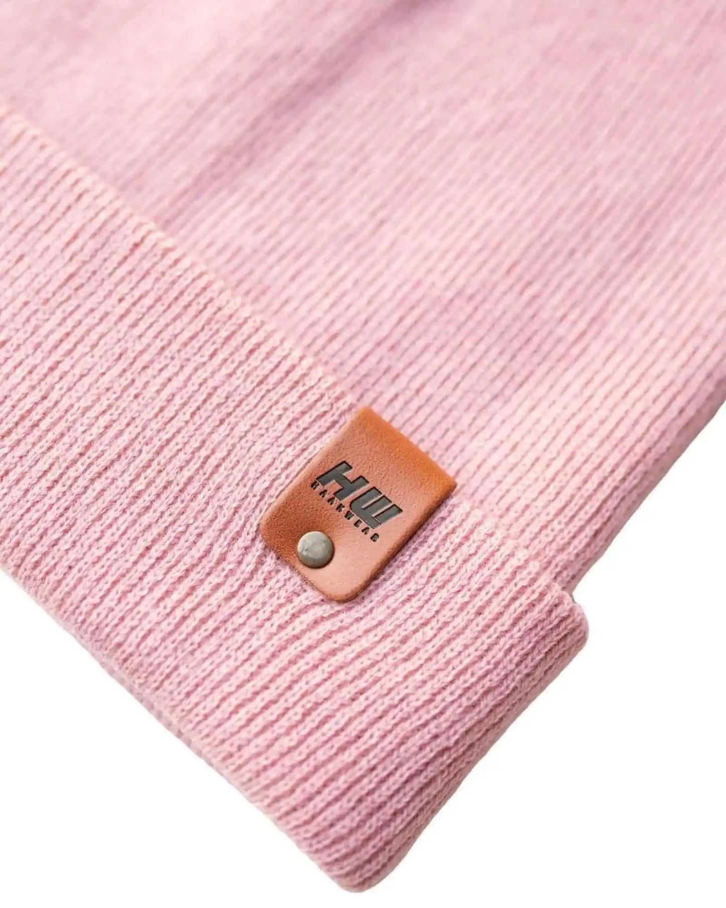 Pearl pink knit beanie with leather cuff patch and metal snap button