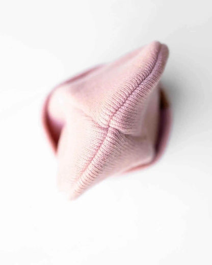 Pearl pink ribbed beanie knit, folded cuff and rounded top detail.