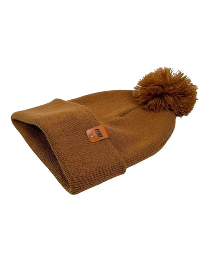 Camel brown cuffed knit beanie with top pom, flat folded with visible tag patch