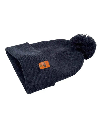 Denim blue knit beanie with folded cuff and pom pom, small orange label patch