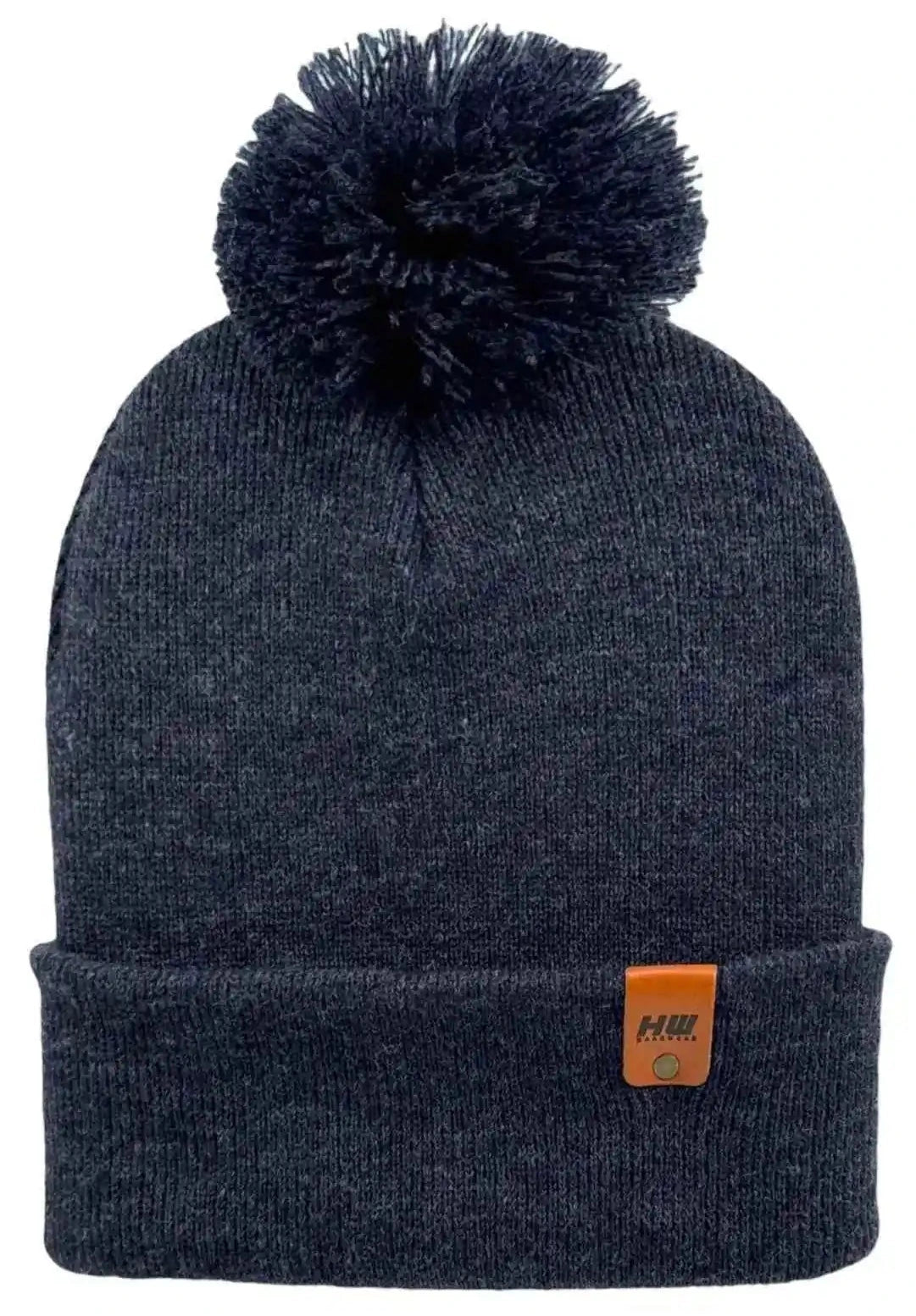 Cuffed pom pom beanie in dark blue knit with large top pom and front patch