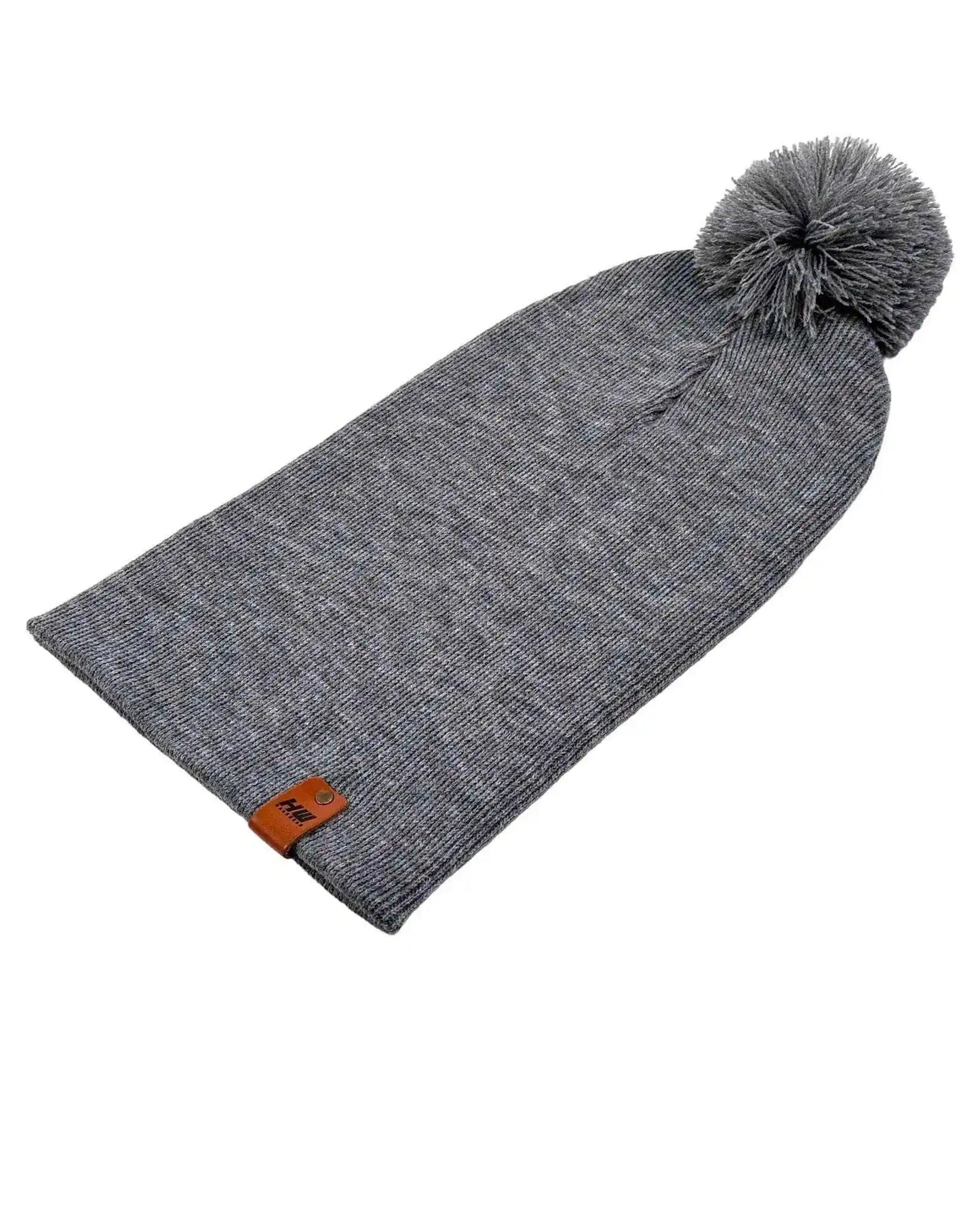 Gray knit beanie with cuff, side logo patch, and gray pom pom on top