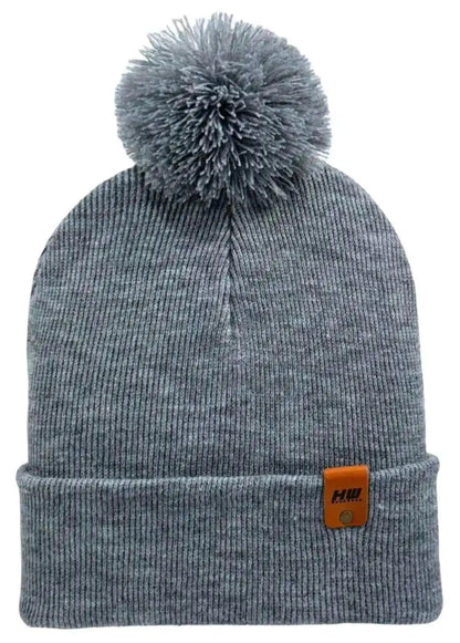 Gray knit beanie with pom pom and ribbed cuff, orange logo patch