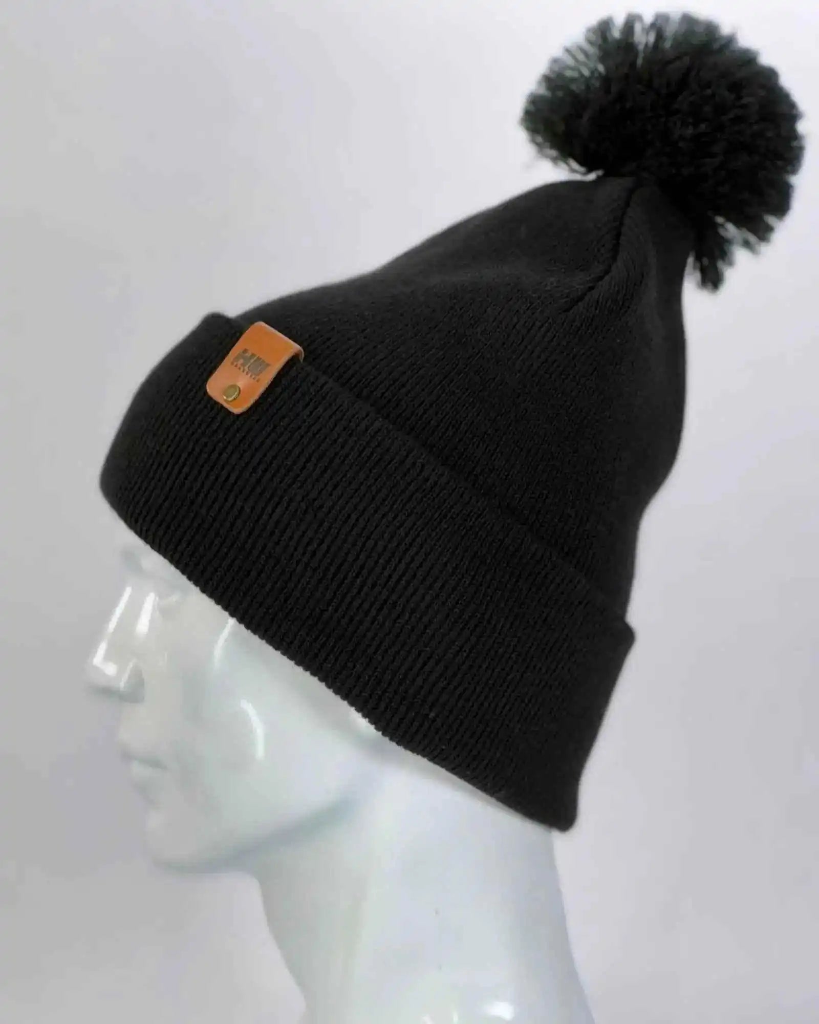 Midnight black slouch beanie with pom pom and orange logo patch on side