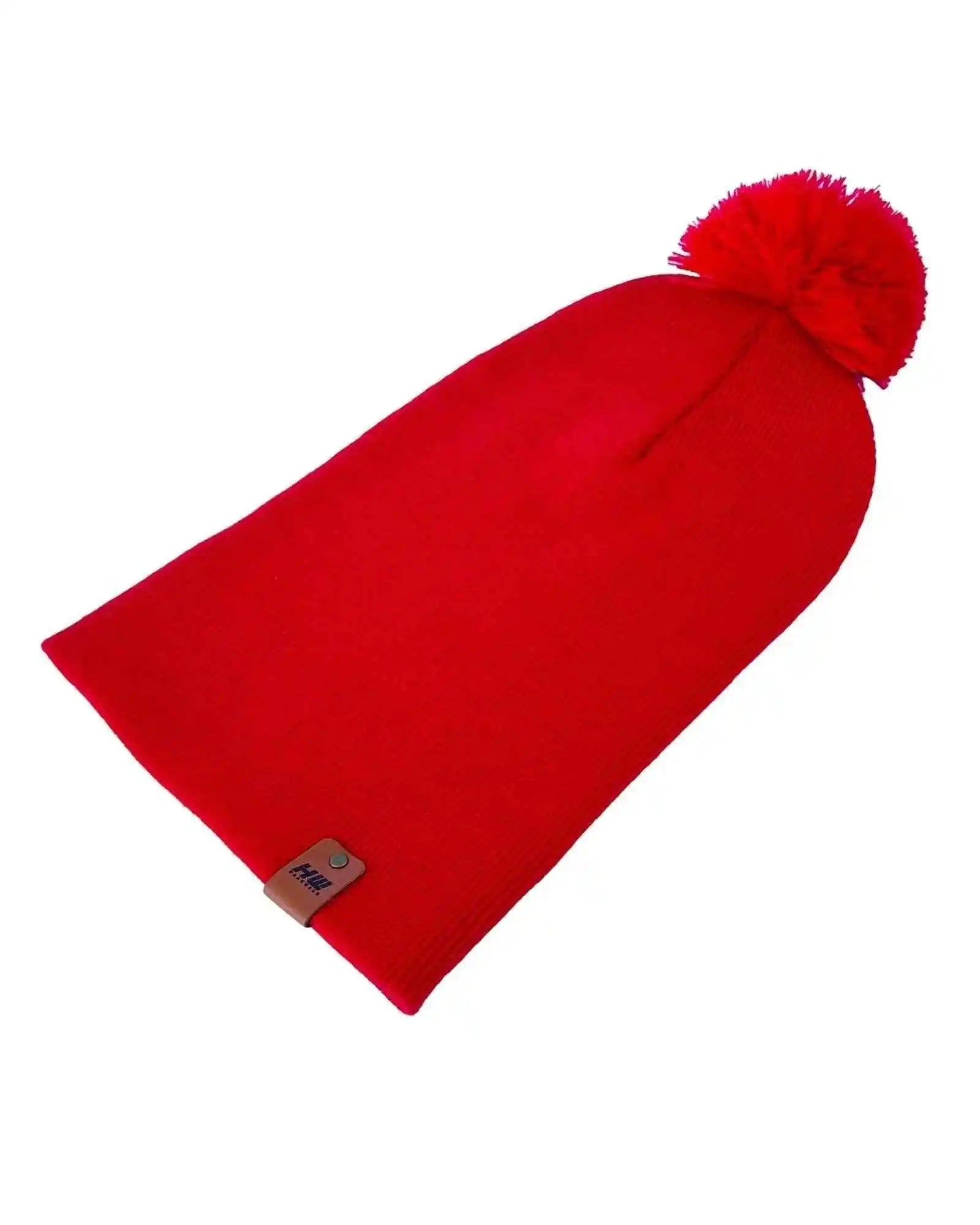 Red cuffed knit beanie with pom pom and small square logo patch on cuff
