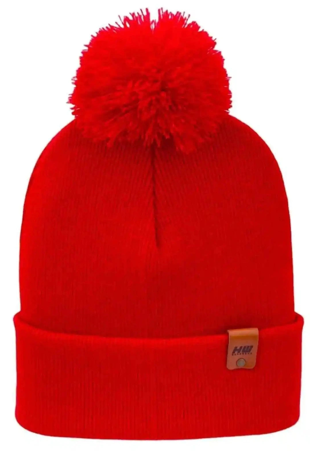 Red knit beanie with large pom pom and folded cuff, small tag on cuff