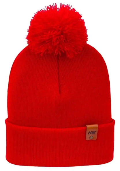 Red knit beanie with large pom pom and folded cuff, small tag on cuff