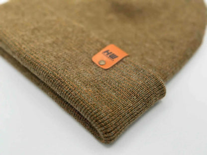 Cuffed beanie knit close-up with orange logo label on fold