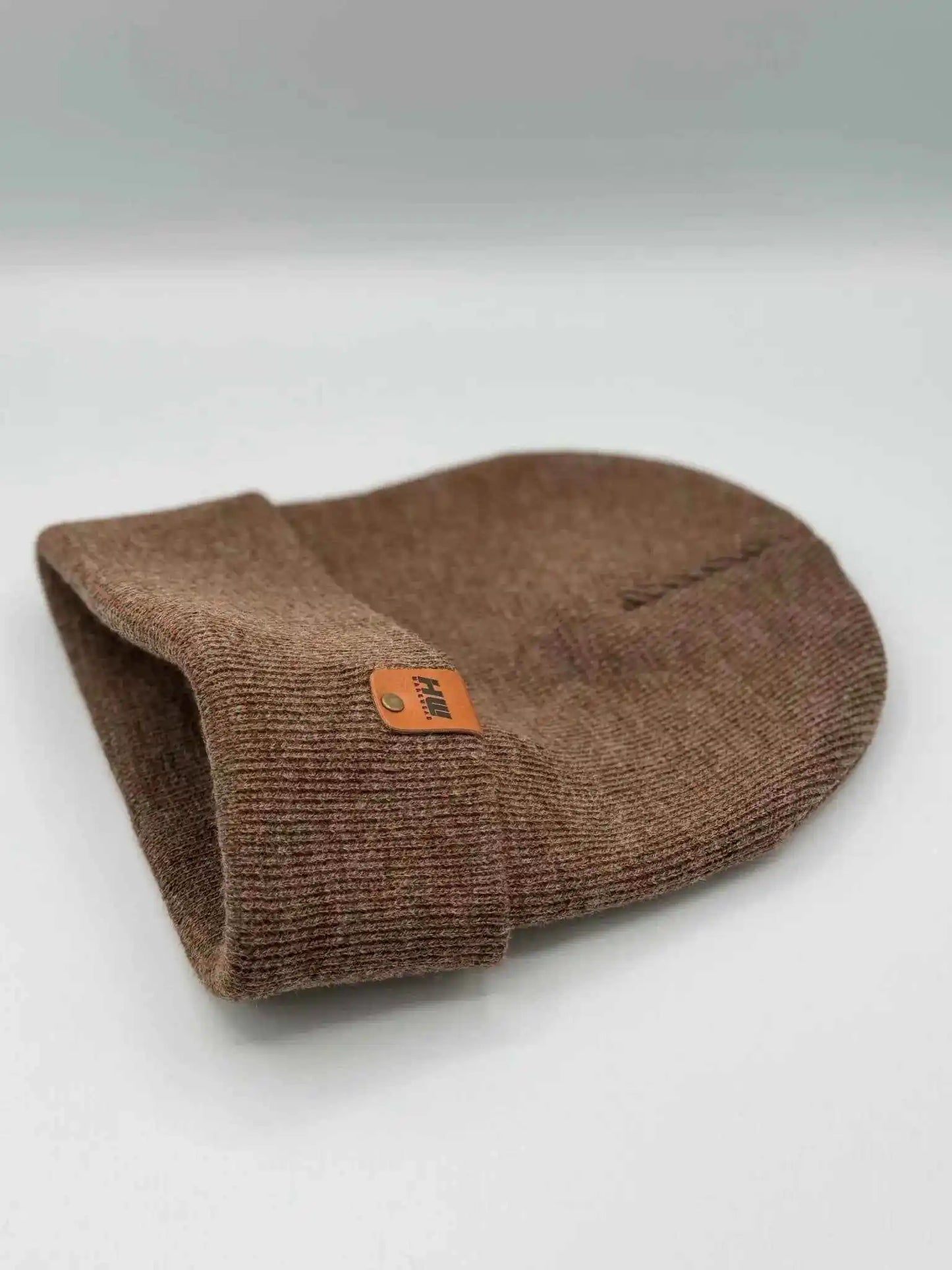 Folded cuffed knit beanie in brown with front woven logo patch