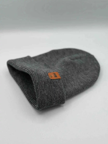 Gray knit cuffed beanie, folded view, orange logo patch