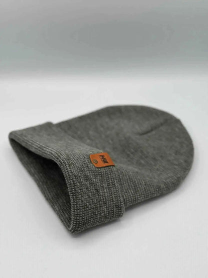 Gray cuffed beanie folded over, orange brand patch on cuff