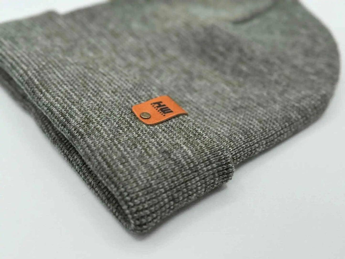Gray knit beanie cuff with orange rectangular brand patch detail