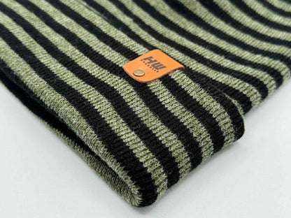Cuffed knit beanie detail: black and green stripes with orange logo patch