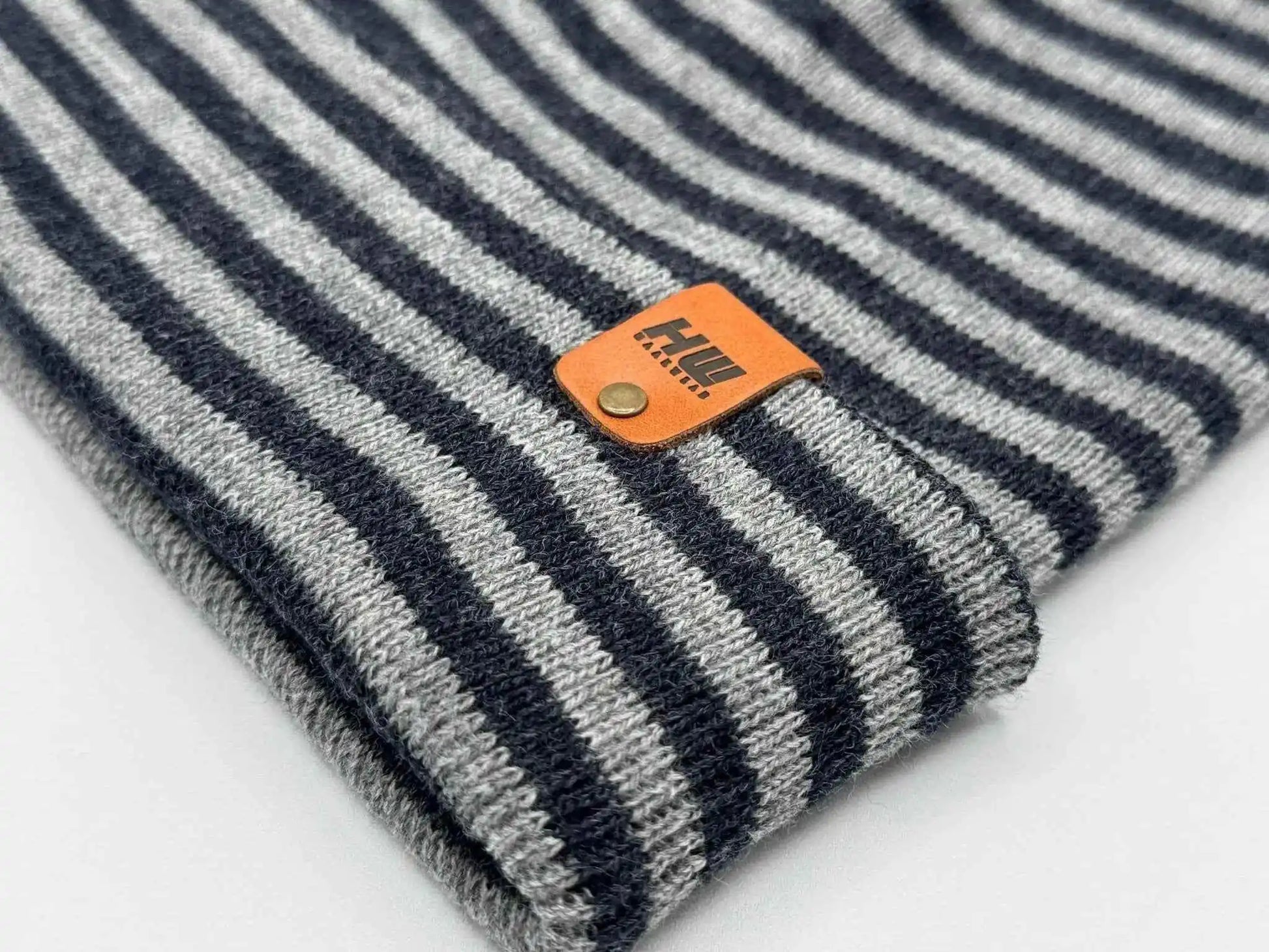 Striped knit beanie cuff with orange brand patch, gray and denim blue