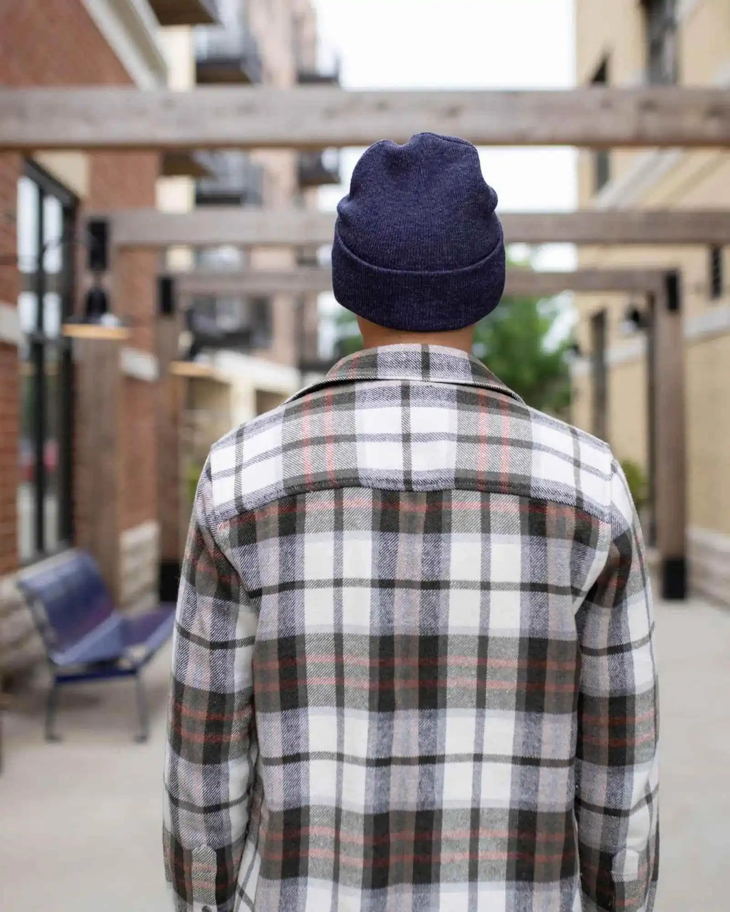 Denim blue cuffed knit beanie on person, viewed from behind